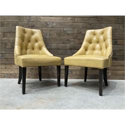 Four high back chairs upholstered in buttoned beige leather, studded detail, rosewood legs