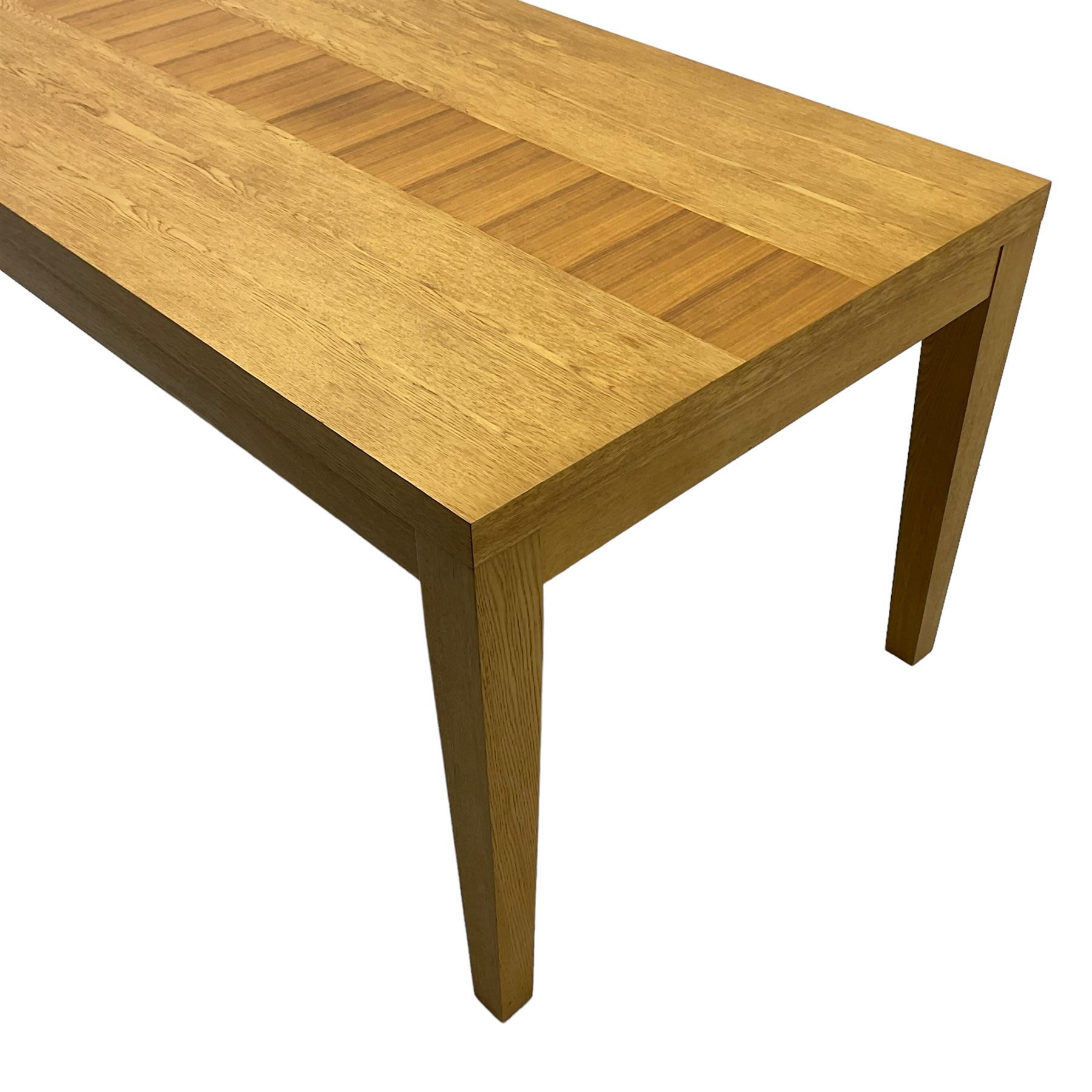 Contemporary oak dining table, rectangular top with inlaid walnut central strip, on square tapering supports 