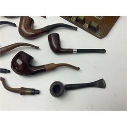 Collection of smoking pipes including Meerschaum pipe, carved as a female head, Briars and clay examples, etc and four pipe racks/stands