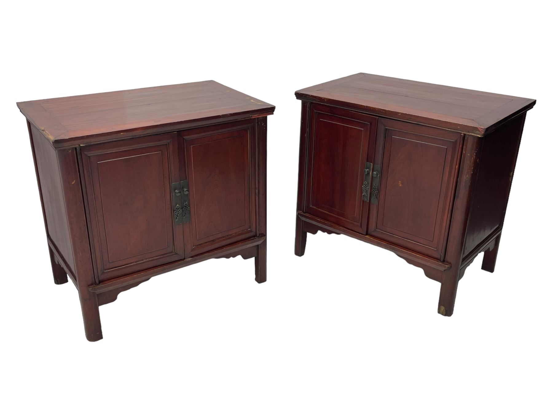 Pair of early 20th century Chinese red lacquered elm storage cupboards, rectangular top over two panelled doors, fitted with two internal drawers, on square supports with curved outer edge, panelled sides