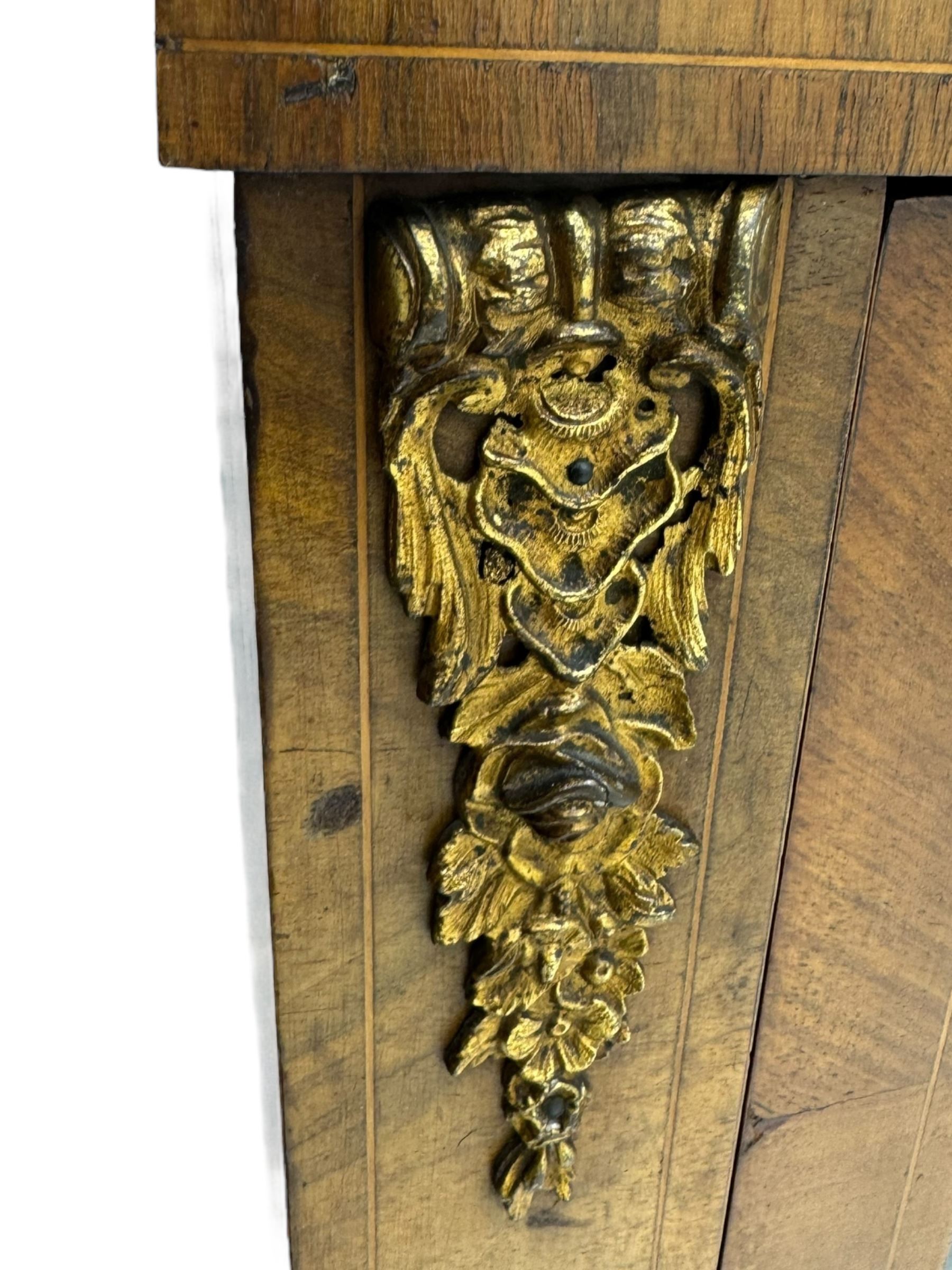 Late Victorian walnut pier cabinet, projecting cornice over frieze inlaid with foliate motifs, single glazed door flanked by ormolu mounts, enclosing shelved interior, on plinth base