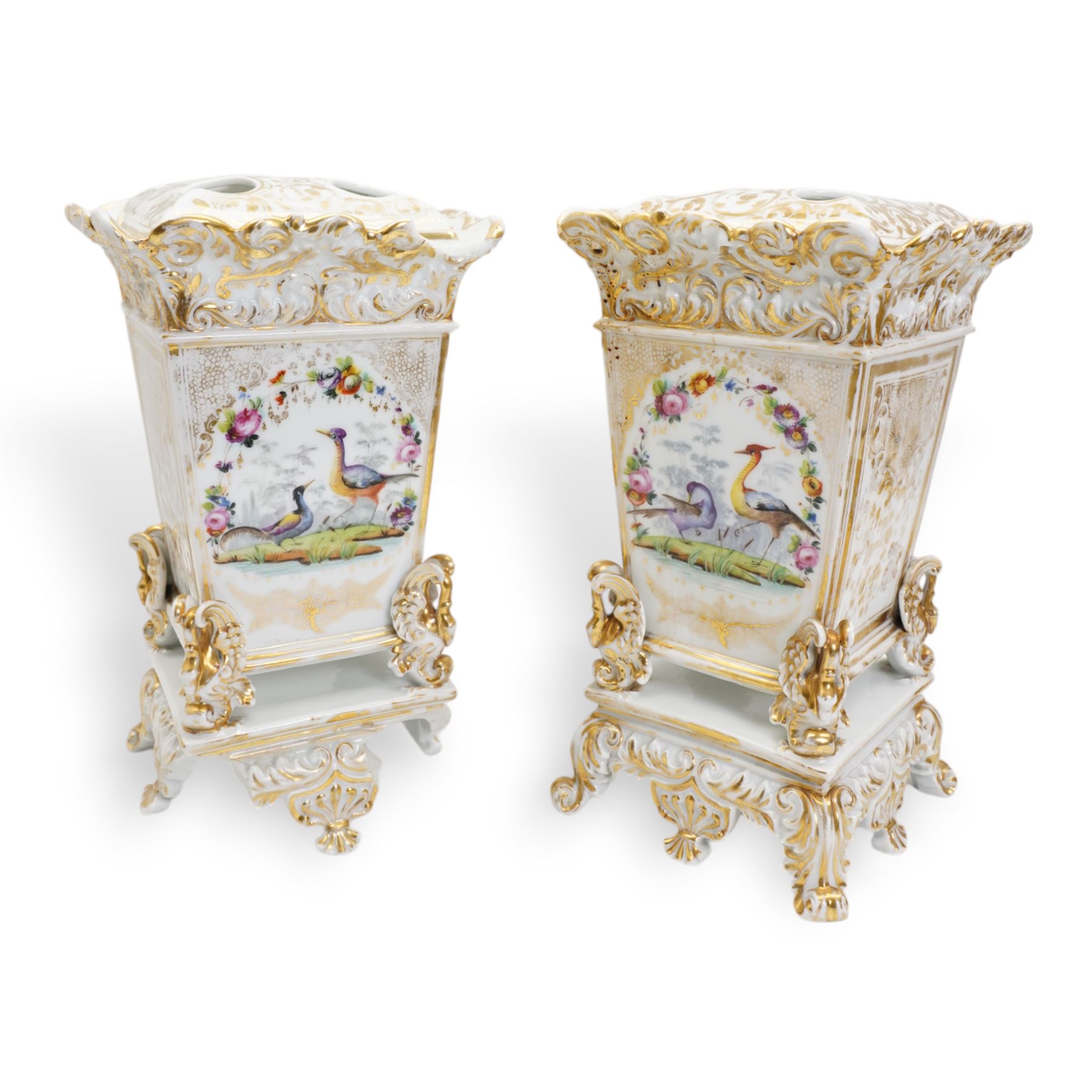 Pair of 19th century French porcelain jardinieres, in the style of Jacob Petit, each of square form, the body painted with panels of exotic birds and sprays of flowers, below a scroll and gilt moulded border, raised upon four swan feet and scroll base, unmarked, H34cm x W20cm