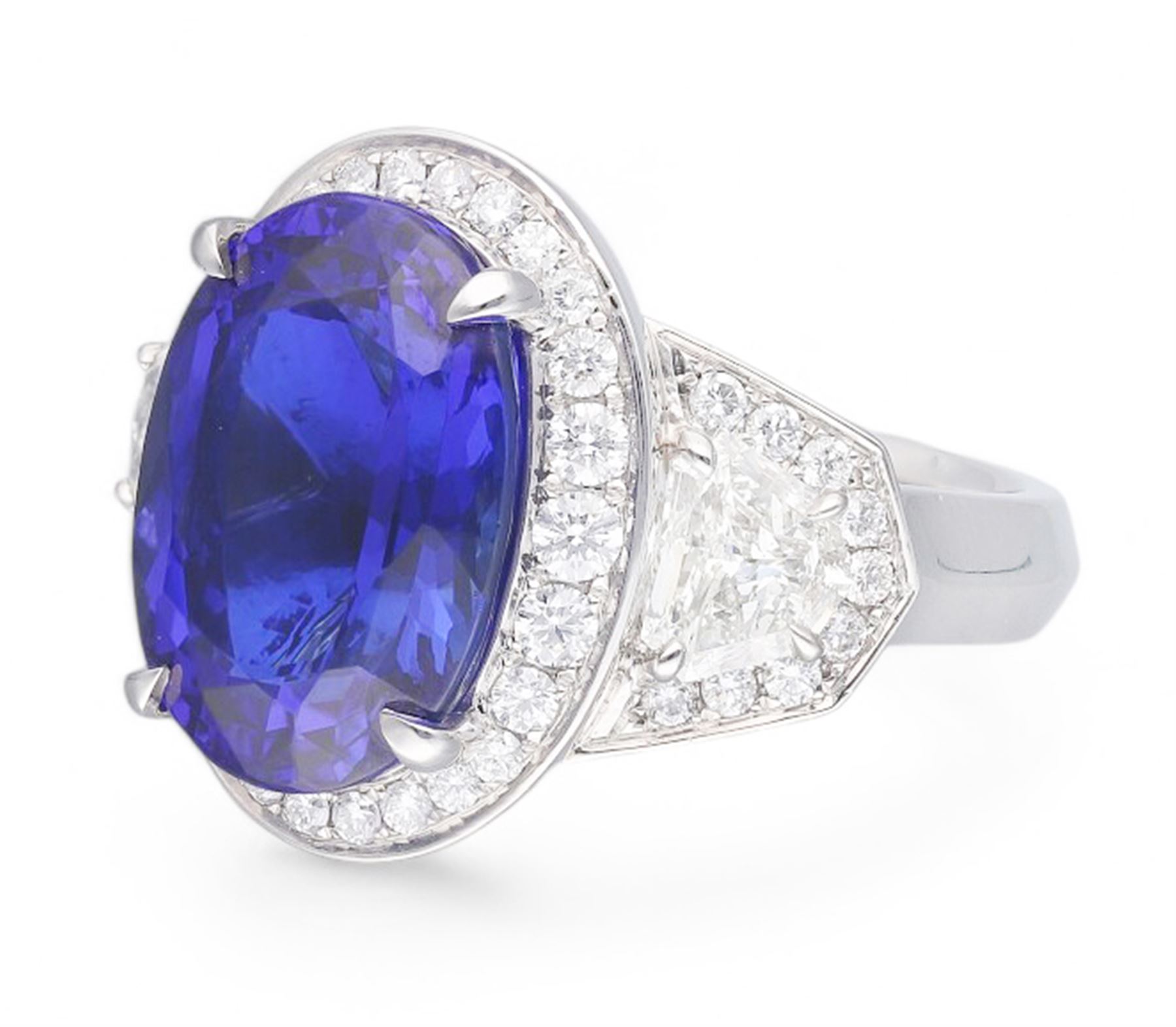 Platinum tanzanite and diamond ring, oval cut tanzanite, with round brilliant cut diamond surround, each side flanked by a single bullet cut diamond, with round brilliant cut diamond surround, hallmarked, tanzanite 9.16 carat, bullet cut diamonds 0.95 carat, round brilliant cut diamonds 0.83 carat