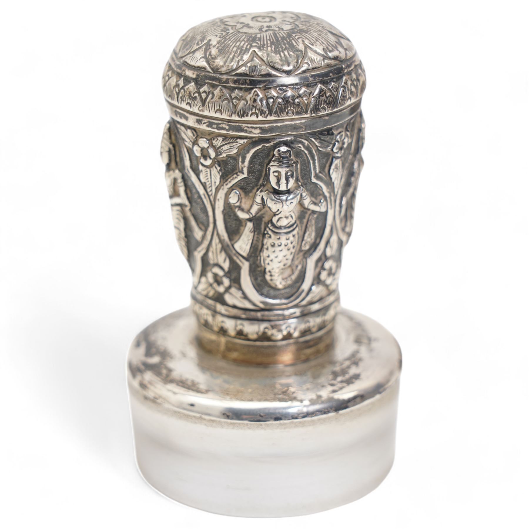 Pair of silver cylindrical dressing table boxes and covers embossed with trailing foliage H7cm, silver upright table photograph frame Birmingham 1909, Indian white metal and glass paperweight and a silver on copper trinket box