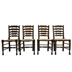 Matched set of eight (7+1) oak ladder back dining chairs, waved ladder back over rush seats, on turned supports joined by turned stretchers