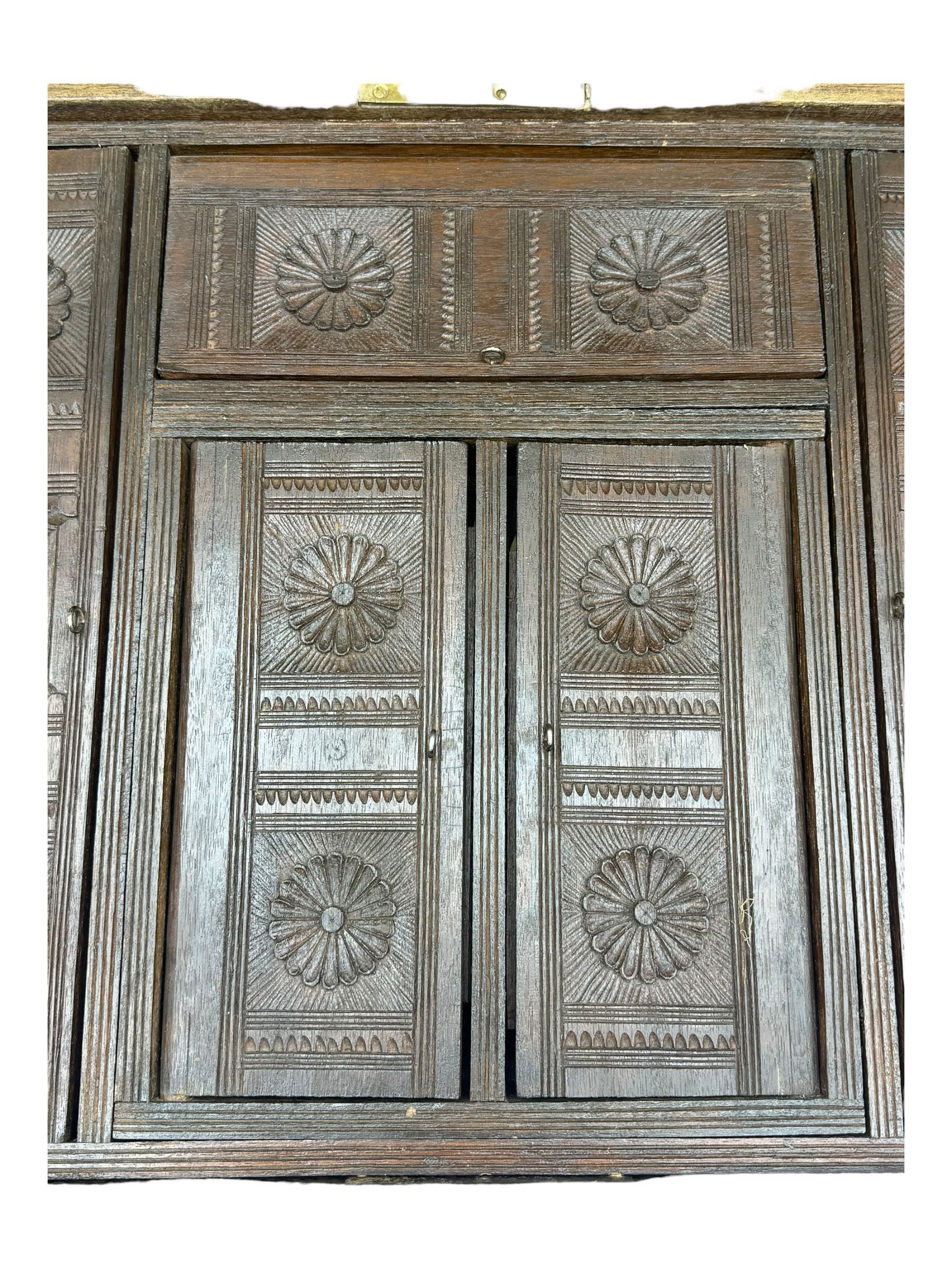 20th century mahogany chest, rectangular hinged top enclosing removable compartments with carved starburst motifs with linear and geometric patterns, brass inlay to the top and front, mounted corners and edges, on bracket base