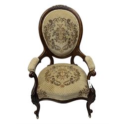 Pair of Victorian walnut lady's and gentleman's drawing room chairs, arched cresting rail carved with cartouche and extending foliage, upholstered in floral pattern fabric, on foliate carved cabriole feet