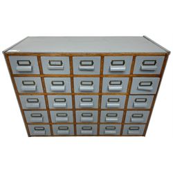 Mid-20th century multi-drawer chest or filing cabinet, fitted with twenty-five small drawers with wooden handles and metal label holders, in light blue paint finish 