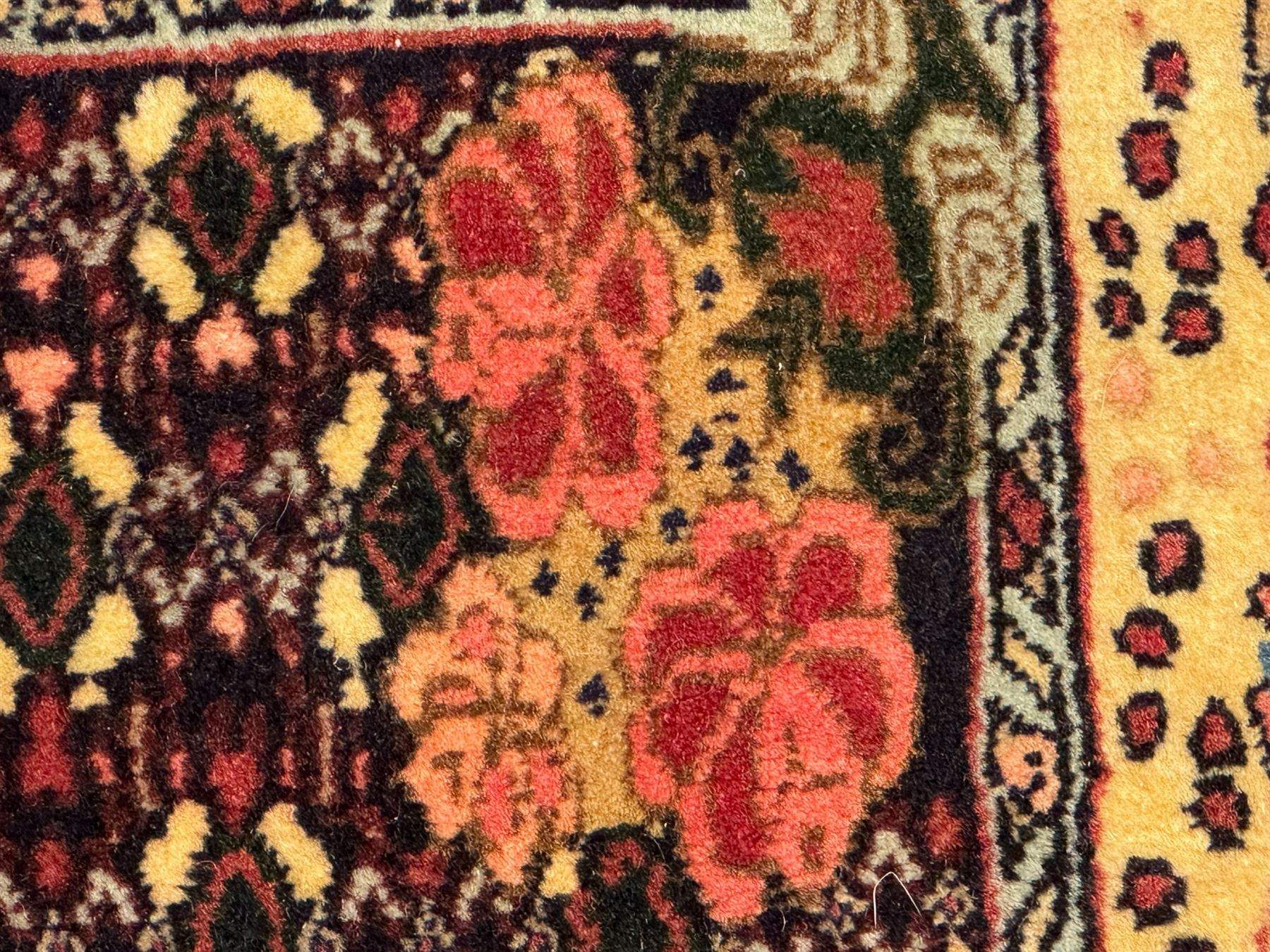 Kurdish rose ground runner rug, set with a series of ten floral medallions on linked field, the border decorated with stylised flower heads and bird motifs 