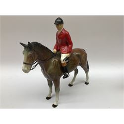 Beswick Hunting Group, comprising: two huntswoman on grey horses, model no 1730, huntsman on a bay horse, model no 1501, a seated fox, model no 1748, eighteen fox hounds and a spaniel, model no 967, all with printed marks beneath, together with three other ceramic huntsman on horseback and two hounds. 