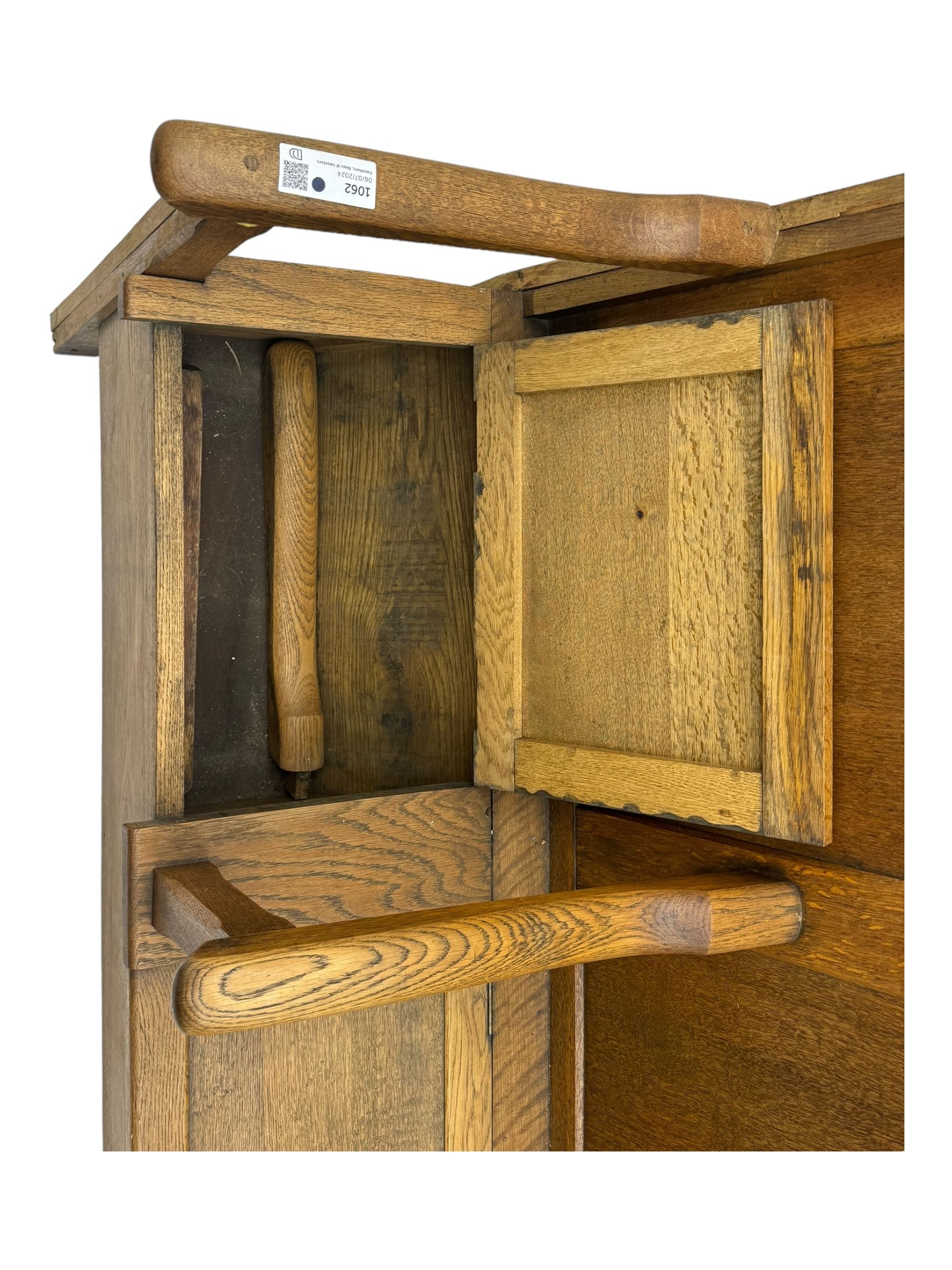 Early 20th century oak settle, featuring a high back with three panel sections and hinged lids, the bench seat divided into three sections, each with its own armrests, supported by square legs