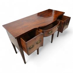 George III mahogany break bow-front sideboard, fitted with three drawers, the corner brackets inlaid with quarter shell motifs, pressed brass oval handle plates decorated with oak leaves and acorns, on square tapering supports