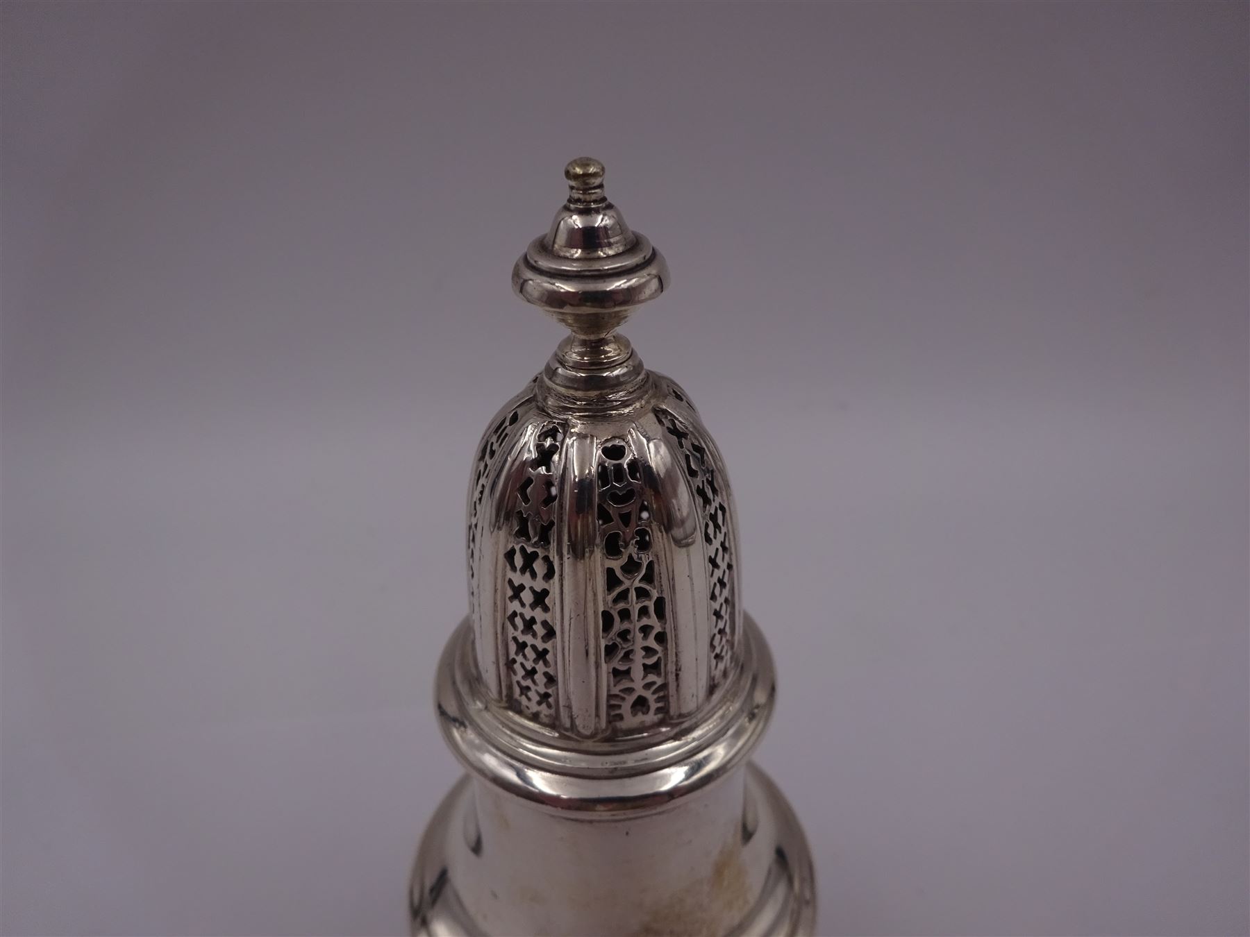 Mid 20th century silver sugar caster, of typical waisted form with removable pierced cap and urn finial, hallmarked William Comyns & Sons Ltd, London 1961, H14cm