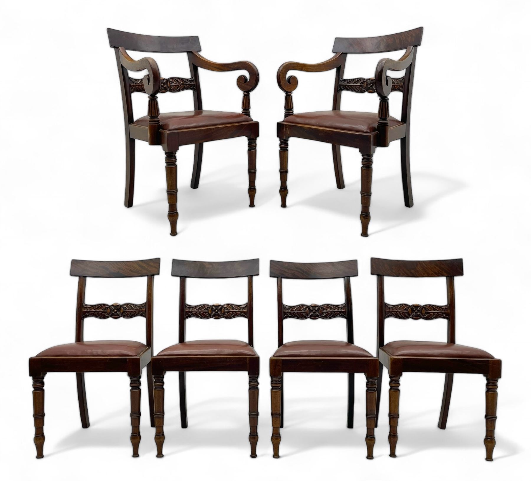 Set of six (4+2) early 19th century mahogany dining chairs, figured bar back over rose and curled leaf carved middle rail, drop-in seats upholstered in brown fabric, on turned front supports 