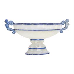 Lapis lazuli and agate twin handled pedestal bowl of navette form, the handles carved as harpies, upon a pierced oval pedestal, 19cm