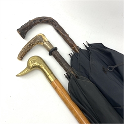 A silver mounted umbrella with stag horn handle, hallmarks worn and rubbed, probably London, maker's mark C.C, probably for Charles Cooke, with further retailers mark Brigg, L89.5cm, together with a blackthorn handled umbrella, and a brass topped walking cane, the handle modelled as the head of a duck. 