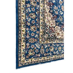 Persian Nain blue ground carpet, overall arabesque design, centre rosette medallion with eight projecting palmettes, the surrounding field decorated with interlacing branches and stylised plant motifs, within floral pale ground spandrels, the guarded border decorated with repeating stylised floral pattern 