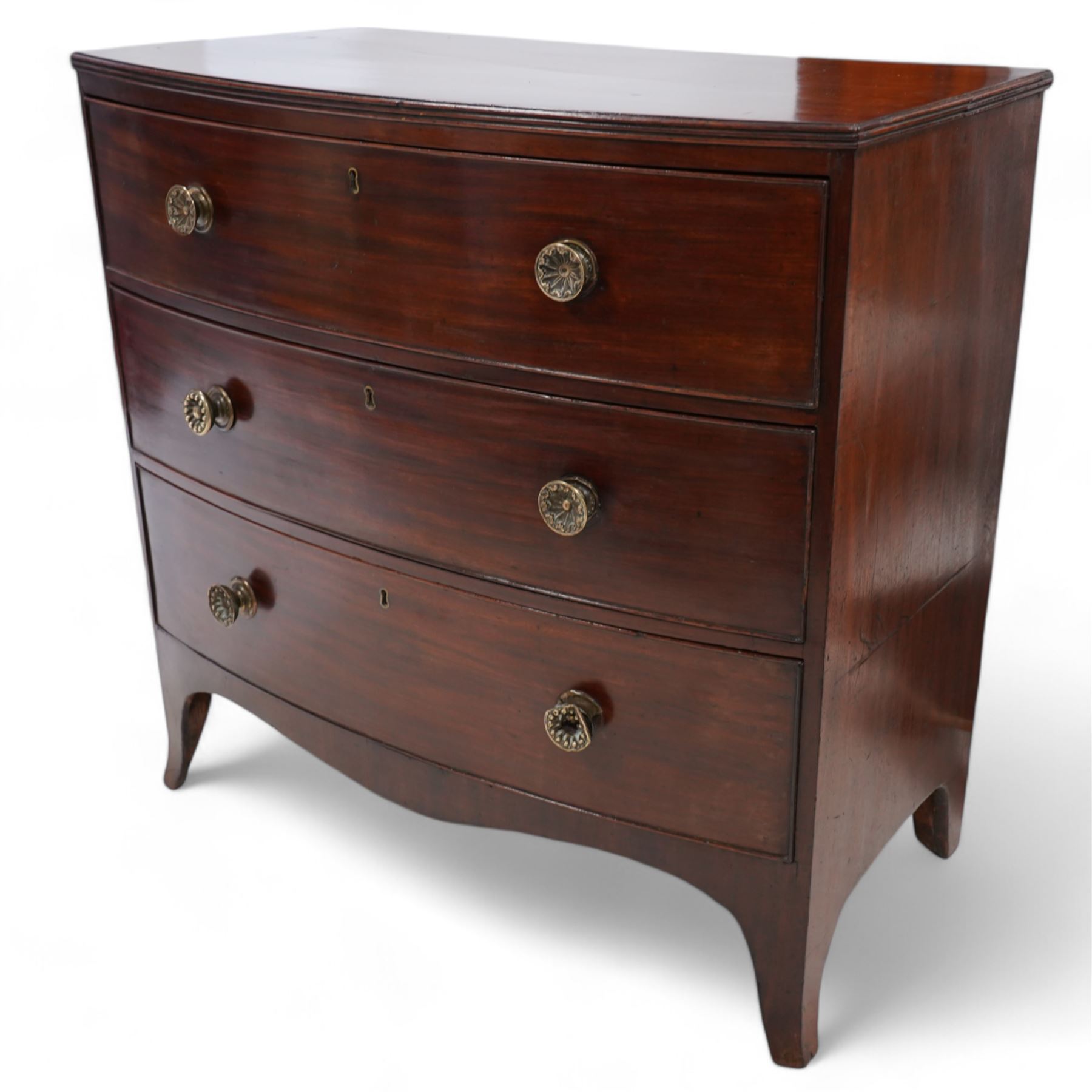 George III mahogany bow-fronted chest, shaped rectangular top with reed edge, fitted with three graduating cock-beaded drawers with brass pull handles, shaped apron over splayed bracket feet