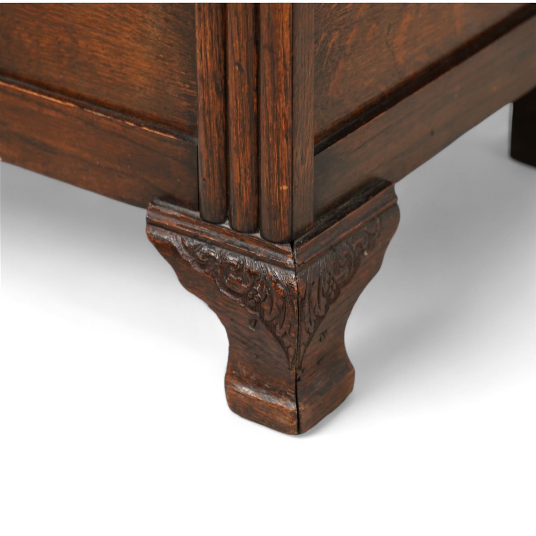 Early 20th century oak blanket chest, rectangular hinged top over triple panelled front with moulded decoration, on foliate carved ogee feet