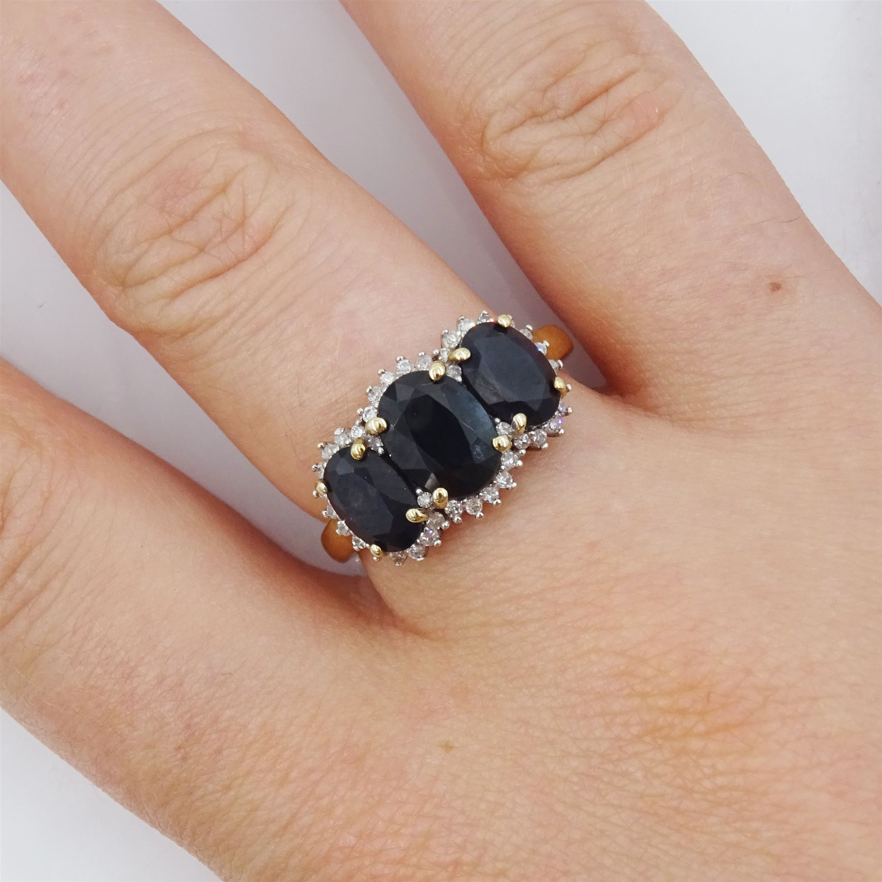 9ct gold three stone oval cut sapphire and round brilliant cut diamond cluster ring, hallmarked