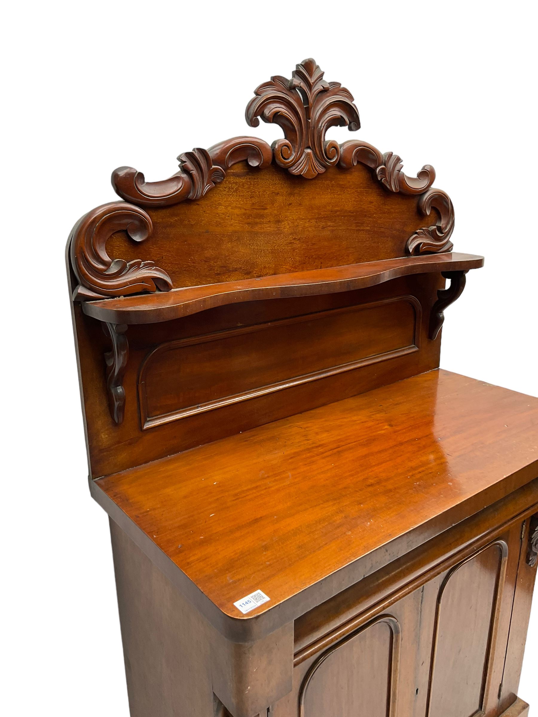 Victorian mahogany chiffonier, raised back with carved C-scroll foliage mounts and shelf, rectangular top with rounded corners over frieze drawer and double panelled cupboard, on skirted base