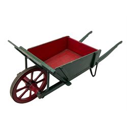 19th century green and red painted wooden wheelbarrow, flat bed with removable sides and back, wooden and wrought metal strap wheel 