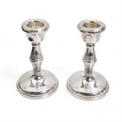 Pair of silver dressing table candlesticks H11cm Birmingham 1959, four various silver serviette rings and a glass and silver coaster