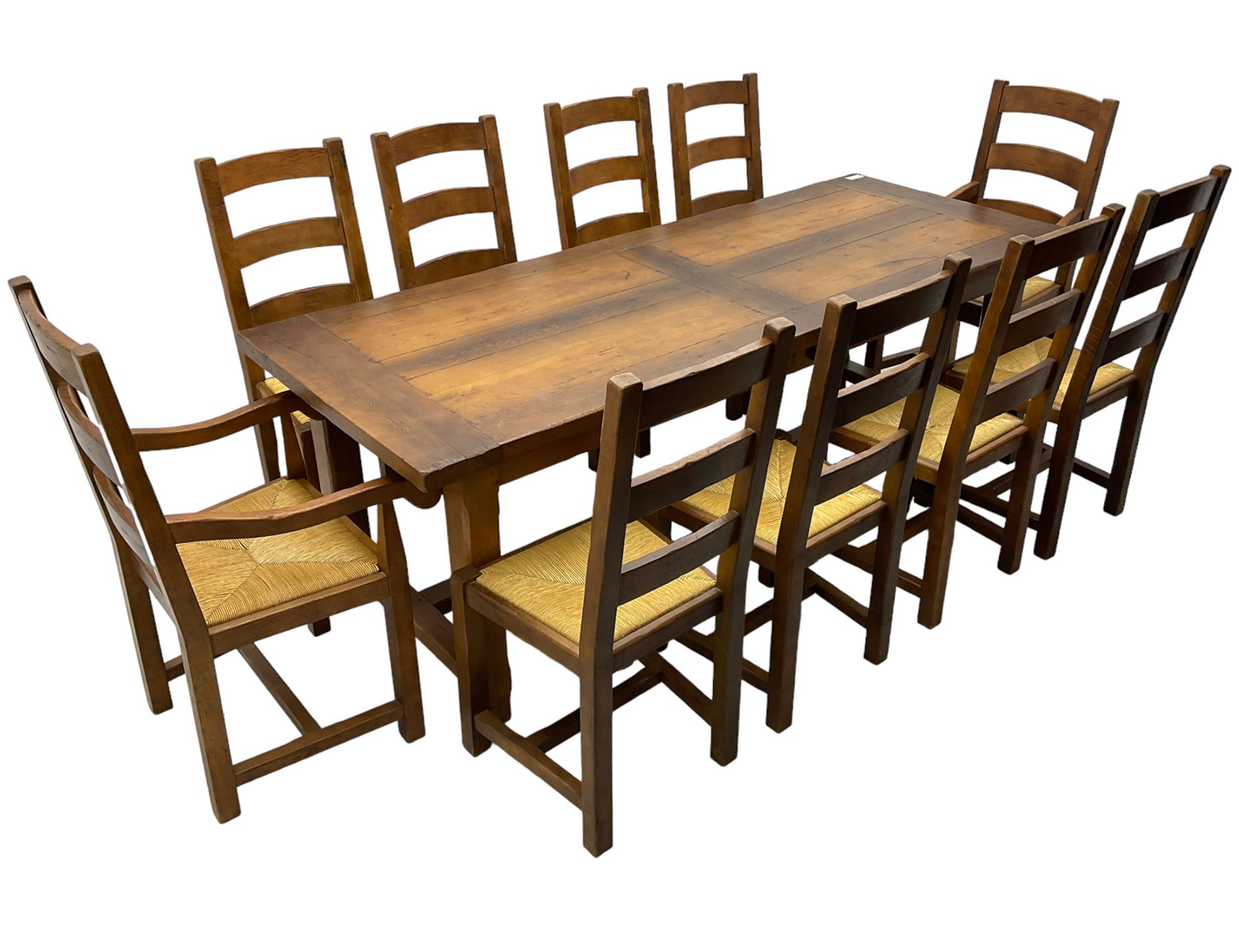 Antix Furniture - oak extending refectory dining table, rectangular plank top with two additional leaves and two drawers to the longer side, on square supports connected by H-stretcher; set of ten (8+2) ladder back dining chairs with rush seats