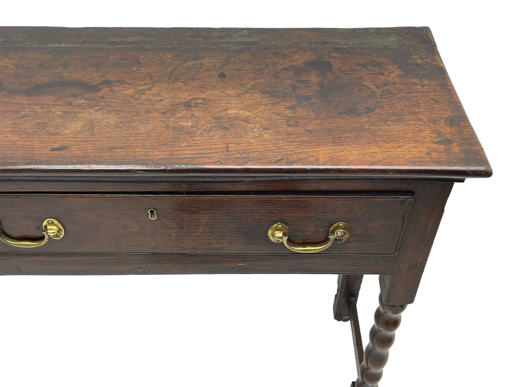 18th century oak dresser base, rectangular top, fitted with two drawers with moulded facia edges and brass swan neck handles, raised on turned front supports united by stretchers