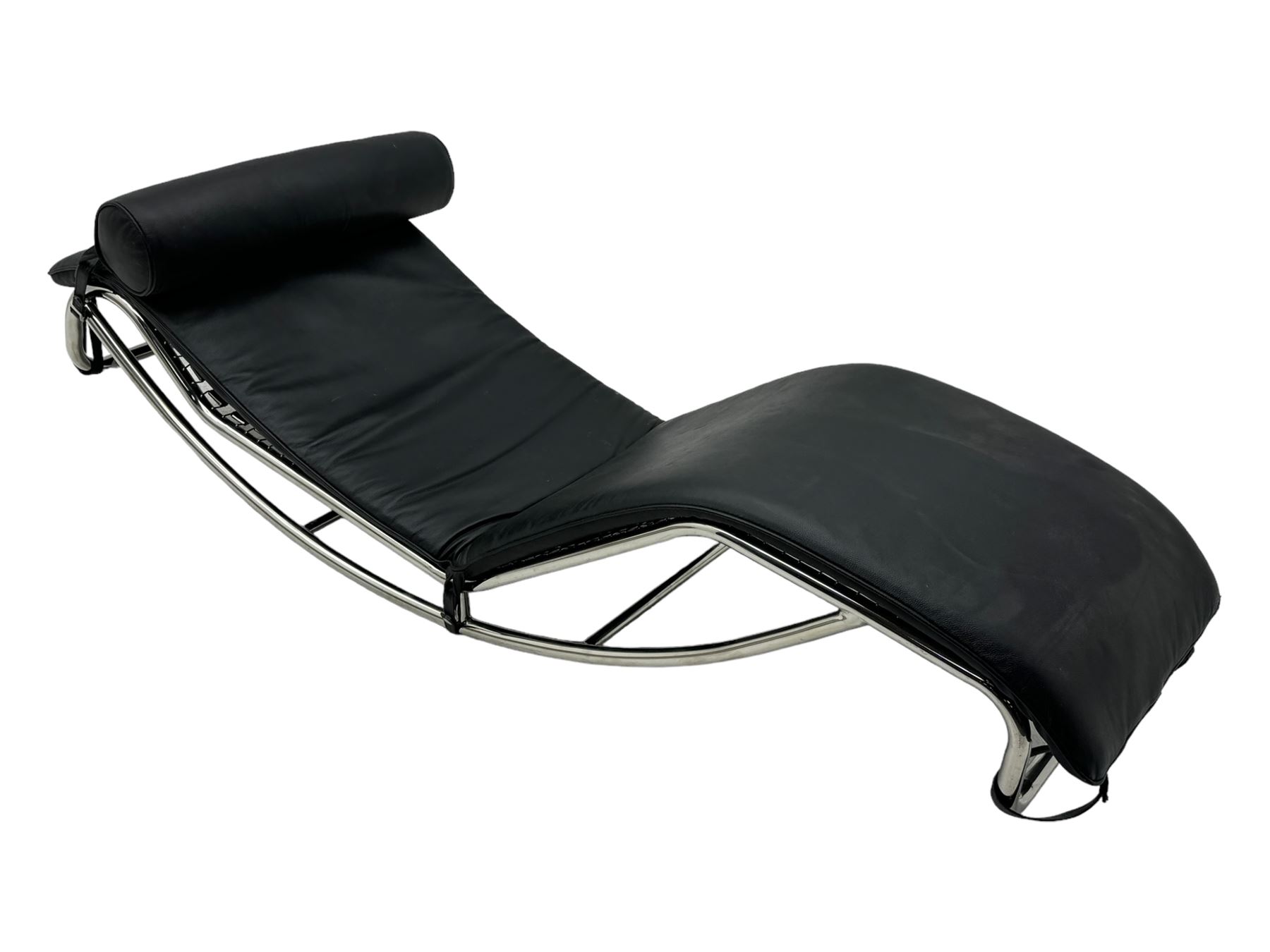 After Le Corbusier, Pierre Jeanneret, and Charlotte Perriand - LC4 chaise longue, black leather upholstery with cylindrical headrest, supported by a chromed tubular steel frame, with cantilever design with elastic webbing