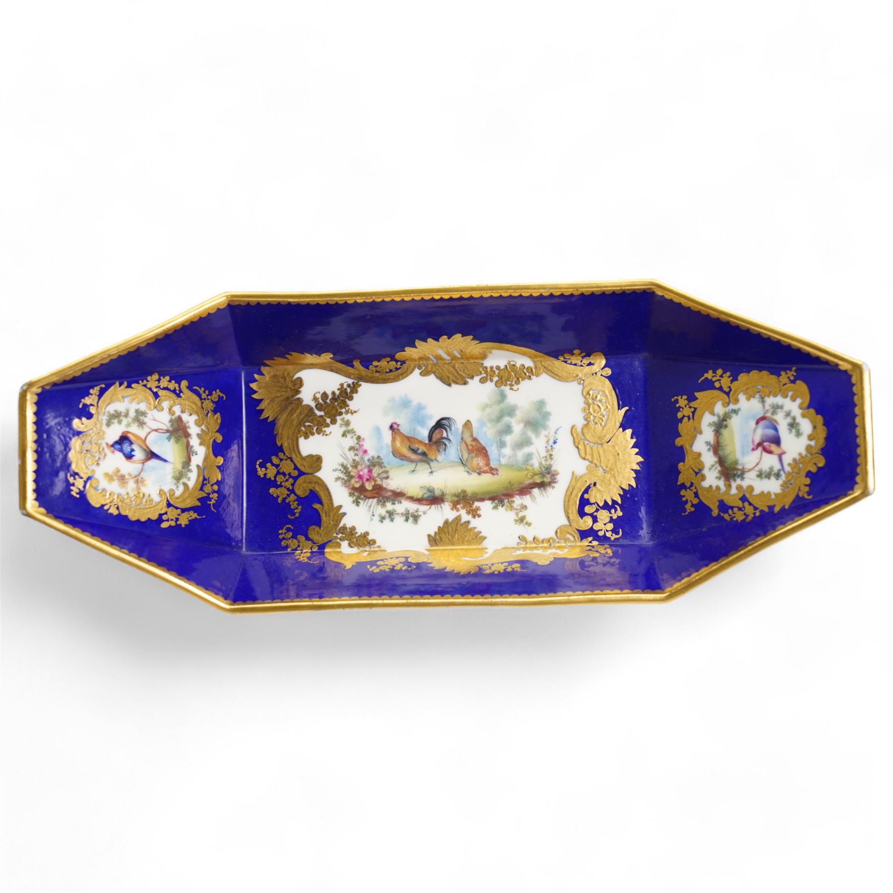 Continental Bleu Royale dish of angular navette form painted with panels of poultry and exotic birds within a gilt surround, pseudo Sevres mark L29cm and a continental yellow enamel box decorated with flowers (2)