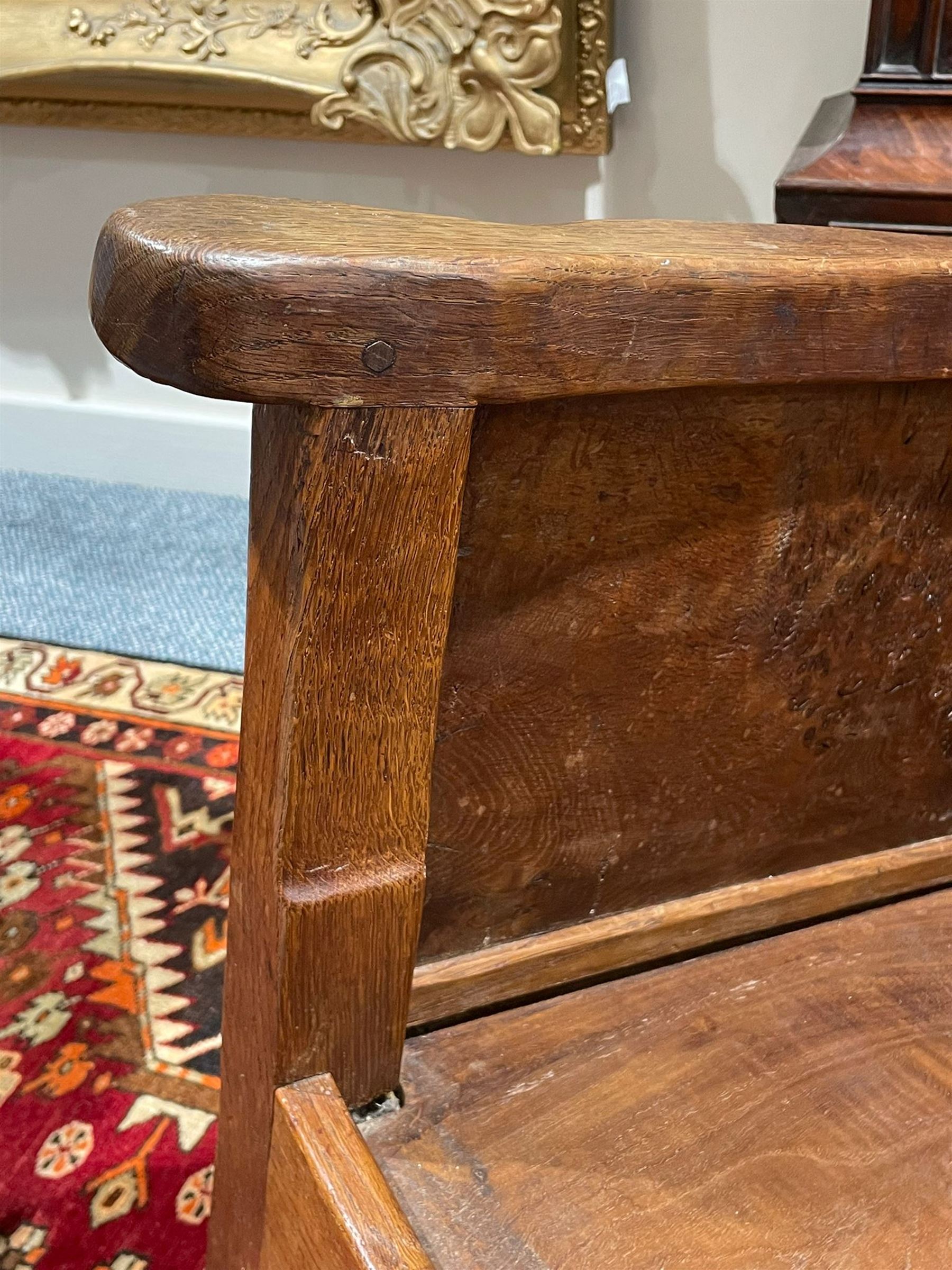 Mouseman - unusual circa. 1930s adzed oak tub-shaped armchair, barrel-back with woven leather, the upright carved with mouse signature, figured panelled sides enclosing panelled seat, arched seat rail, stile supports with block feet on castors, by the workshop of Robert Thompson, Kilburn  

Notes: made by apprentice Graham Hayes (1914-1943). Hayes went on to become a founding member of the Small Scale Raiding Force (SSRF), a special commando unit under the Special Operations Executive (SOE), established by Winston Churchill in 1940. Tragically, he was captured in 1942 and held prisoner by the Gestapo until his execution in 1943. Recently, Hayes has been featured in Guy Ritchie's film 'The Ministry of Ungentlemanly Warfare' under the name 