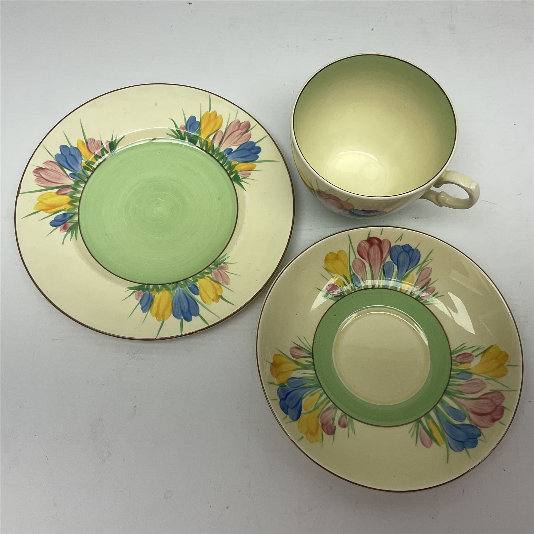 Clarice Cliff trio and plate in Spring Crocus pattern, all with printed mark beneath, plate D25cm 