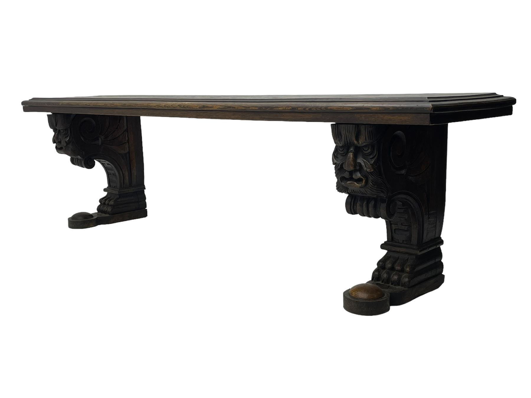 Victorian oak bench, moulded rectangular top, on mask and scroll carved corbel supports with paw feet, rectangular platforms with rounded terminals and applied roundel 