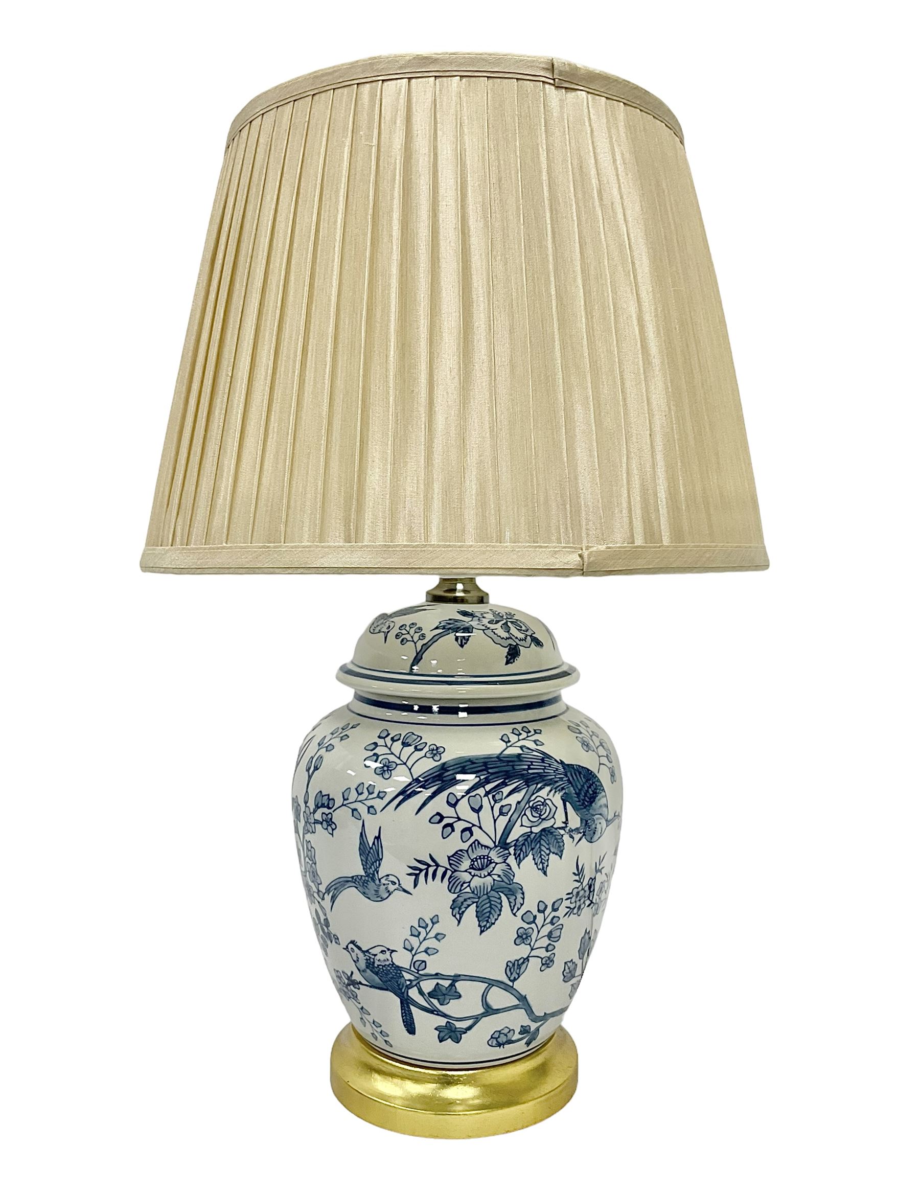 Table lamp of baluster form, decorated with exotic birds up fruiting trees, on gilt chrome pedestal, including shade H554cm