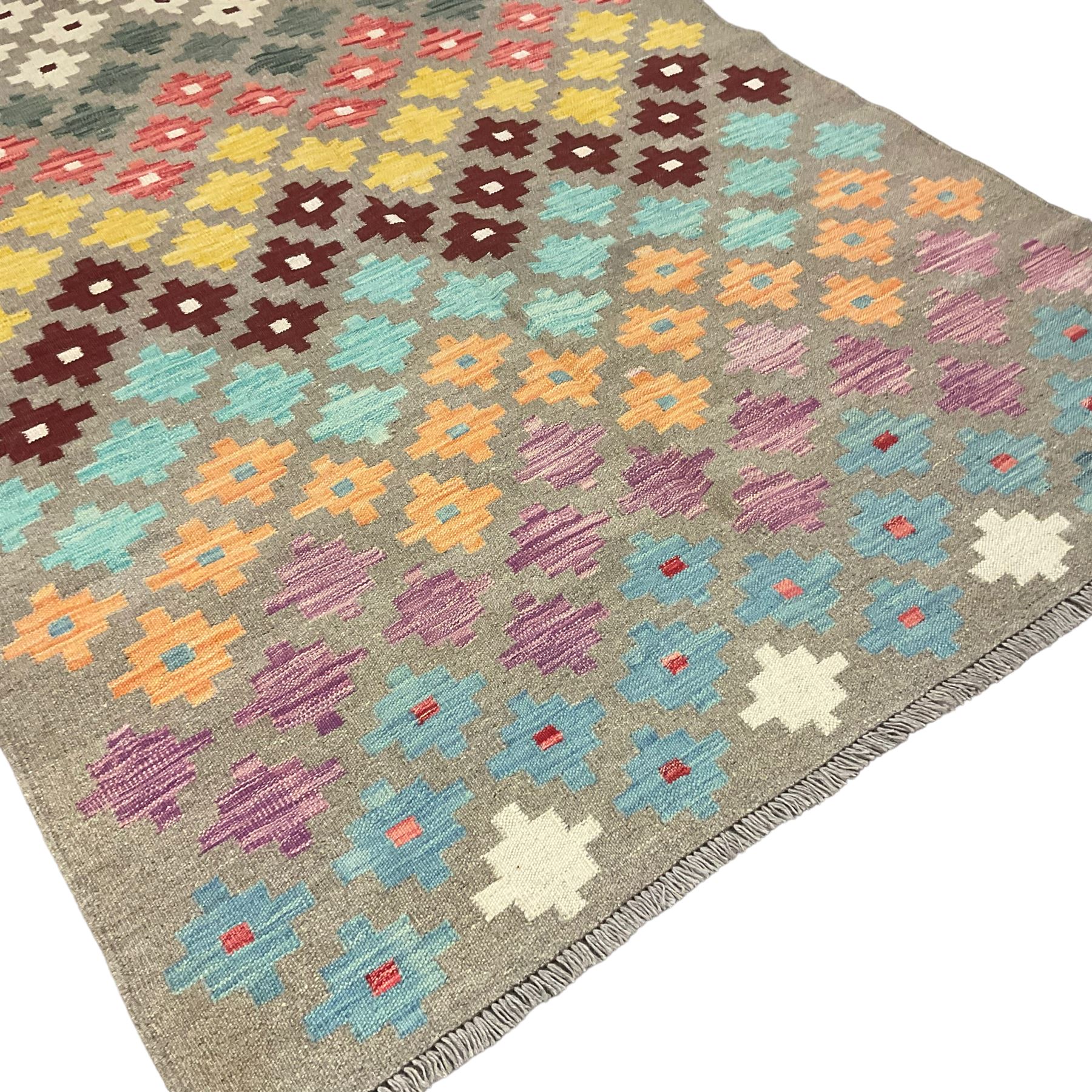 Anatolian Turkish kilim, light grey ground and decorated with multi-coloured geometric star motifs