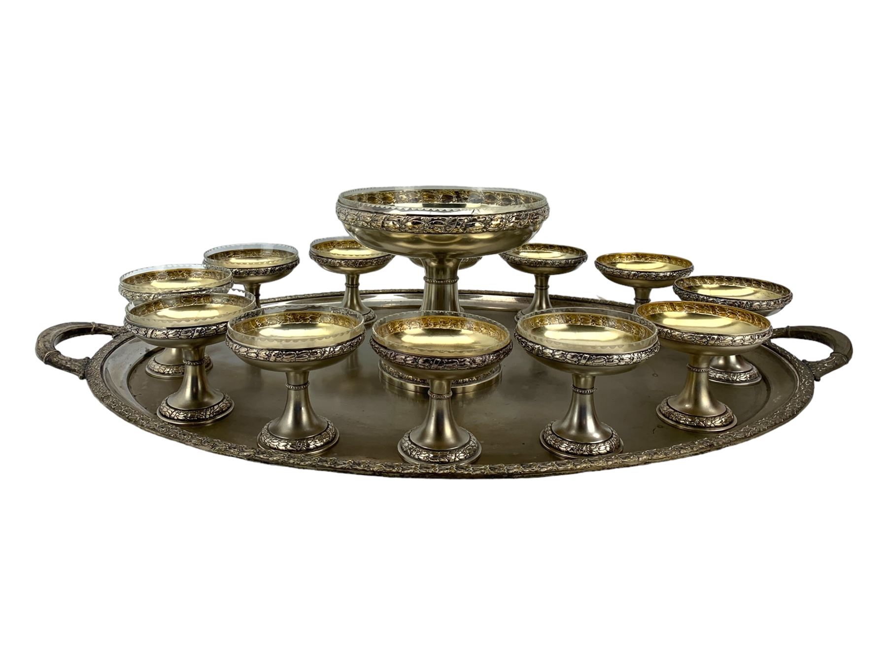 Early 20th century German silver-plated dessert service, comprising a tall comport with clear glass liner, and twelve pedestal bowls, eight with glass liners, with makers mark for Bibus Frantisek & Sohn, on a matching twin handled tray, unmarked, L82cm 