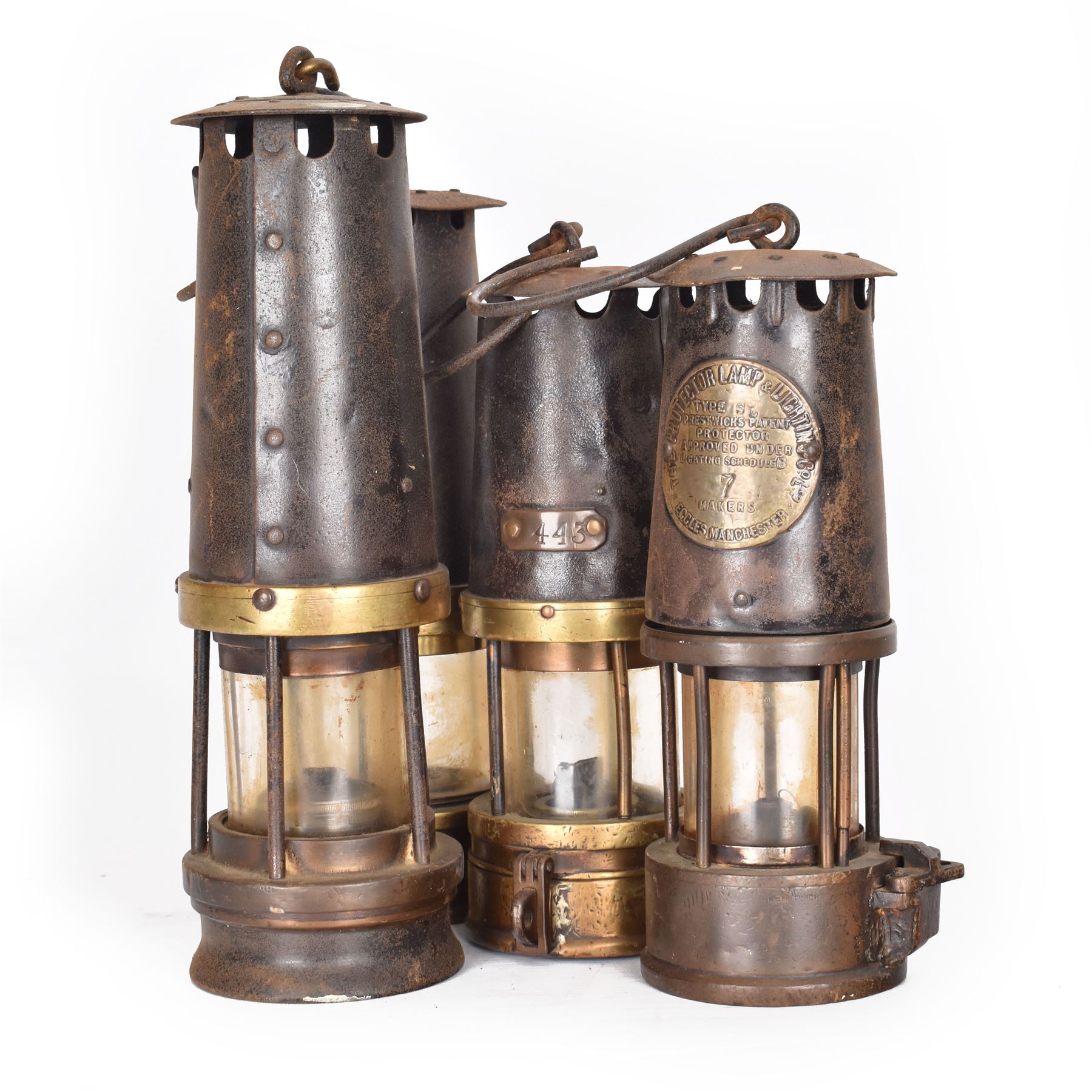 Four miners lamps, including Eccles Manchester example, tallest H30cm