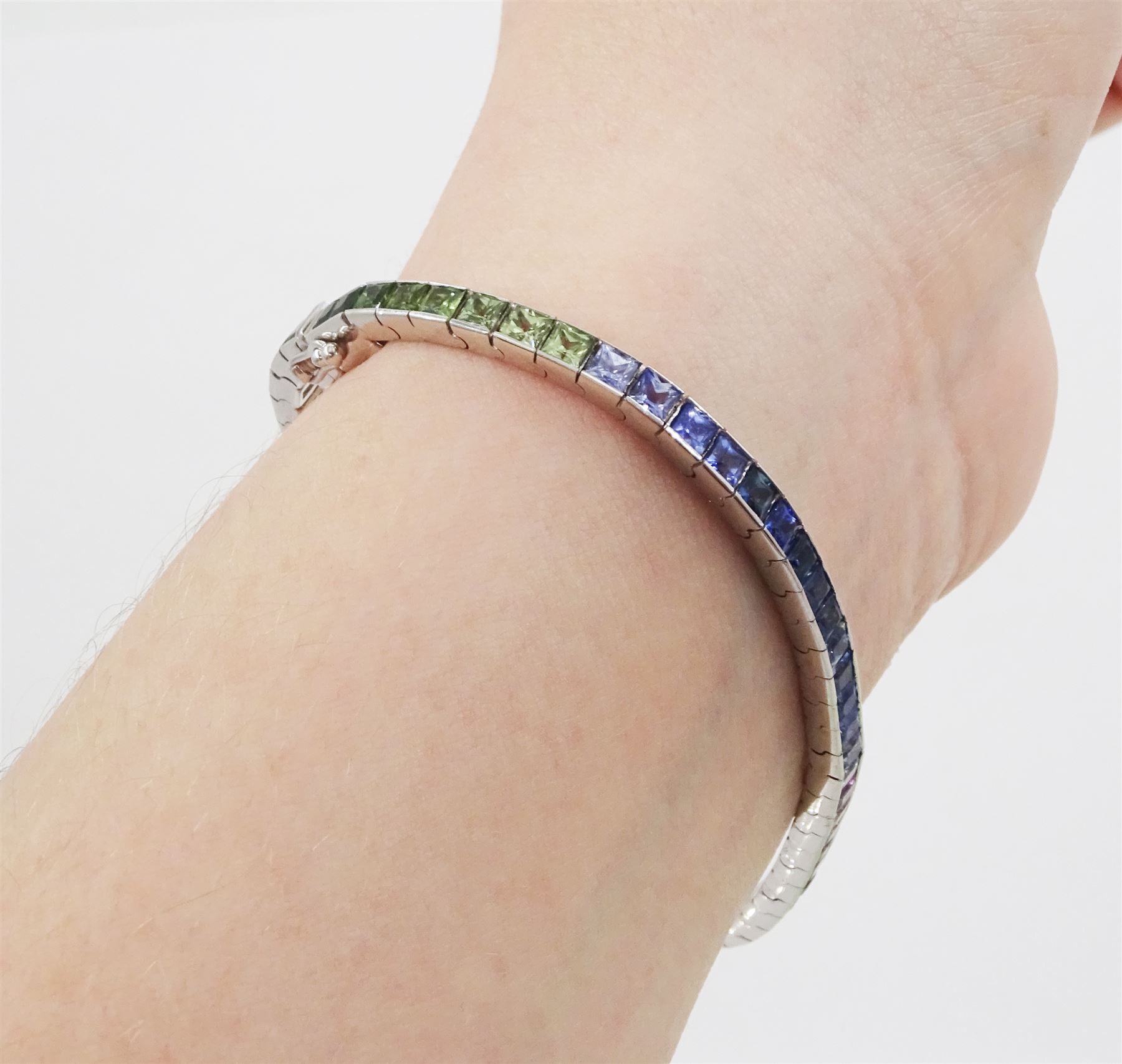 18ct white gold channel set multicoloured sapphire bracelet, sixty-one princess cut sapphires, various hues including blue, pink, green, yellow and teal, London 2004