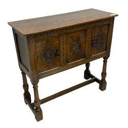 Jacobean design oak cupboard, rectangular top over two doors and central panel, carved with interlacing design with flower head and lozenges, on turned supports united by H-stretchers 