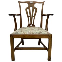 George III walnut elbow chair, shaped cresting rail over shaped pierced splat, the shaped arms with scroll carved terminals, upholstered drop in seat, on square chamfered supports united by plain stretchers 