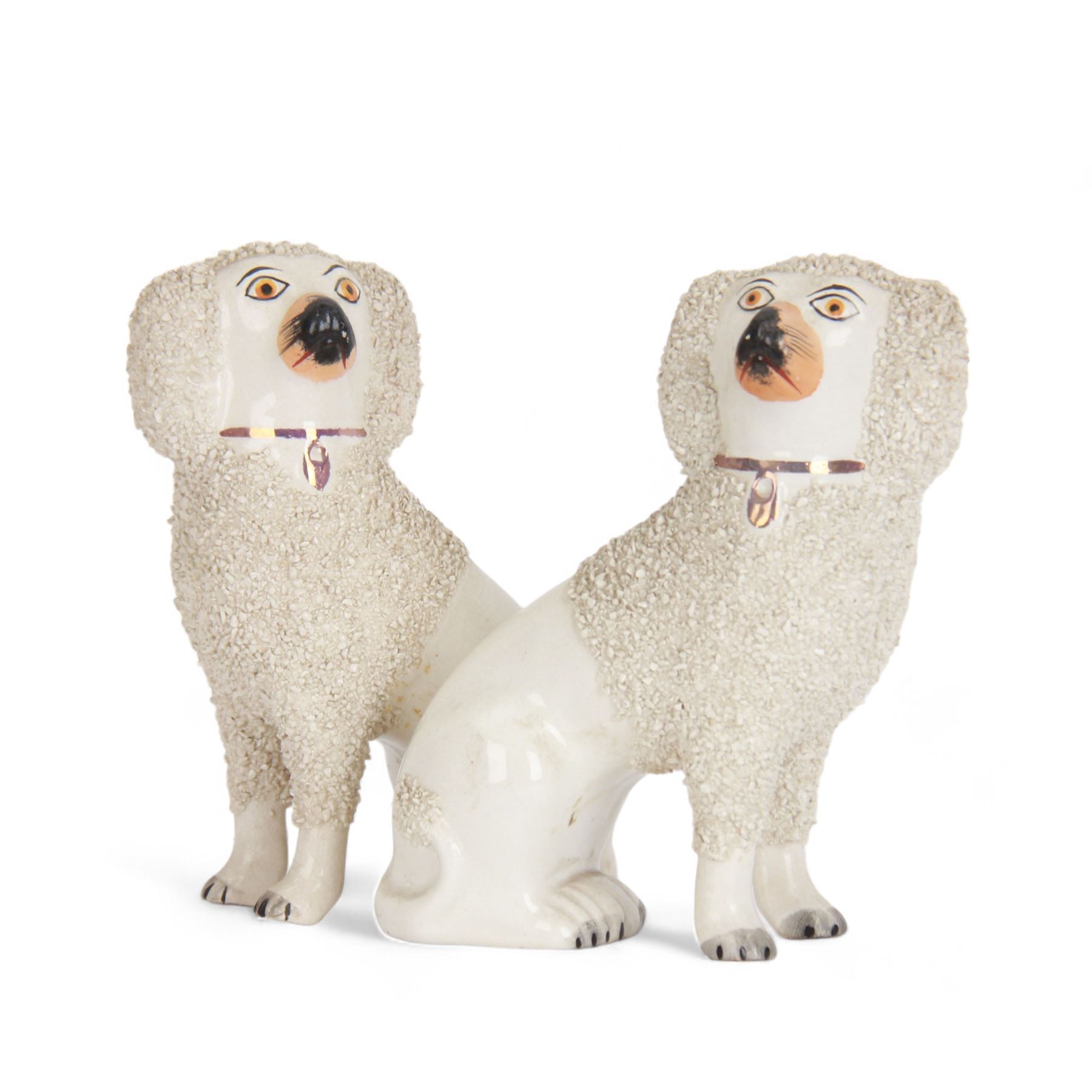 Pair of 19th century Staffordshire pottery dogs, circa 1860, modelled as Poodles with textured ears, upper bodies and tails, H16cm