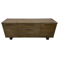 Contemporary dark oak finish sideboard, three central drawers flanked by single cupboards, on angular black finish metal supports 