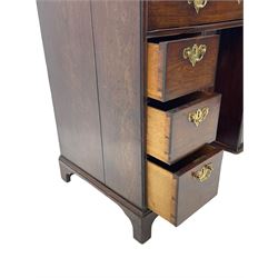 George III mahogany kneehole desk, moulded rectangular top over one long drawer, six short drawers and recessed panelled cupboard, cock-bead moulded frame, fitted with shaped brass handle plates with engraved decoration, on bracket feet 