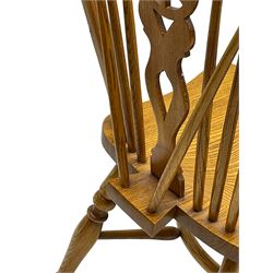 Set of four elm Windsor dining chairs, hoop and stick back with shaped wheel splat, dished seat on turned supports united by crinoline stretcher 