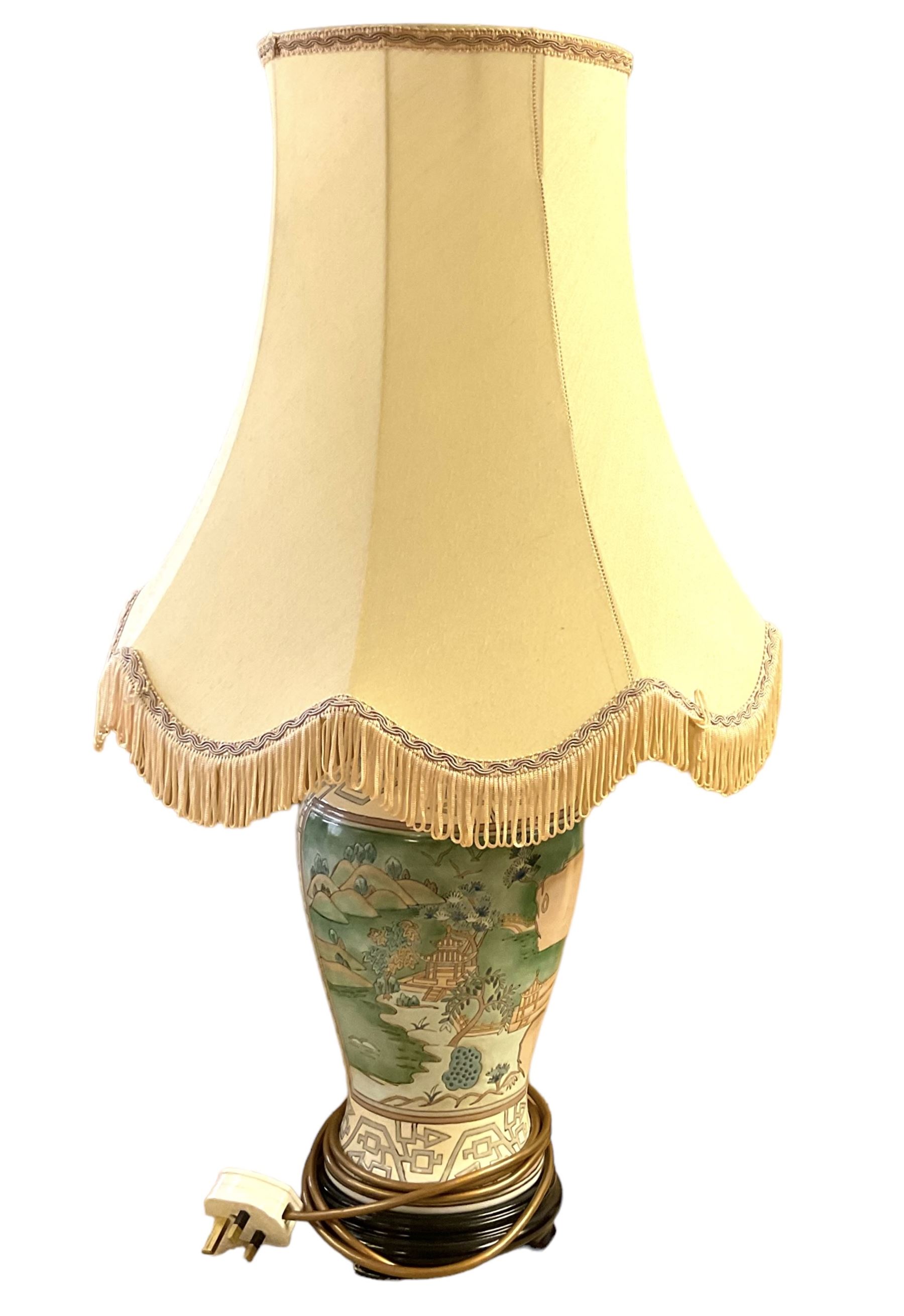 Oriental style table lamp, of baluster form, decorated with landscape scenes, with fabric shade, overall H70cm