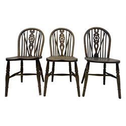 Mid-to-late 20th century set of six elm and beech Windsor dining chairs, hoop and stick back with pierced wheel splat, dished elm seat, on turned supports united by turned stretchers 