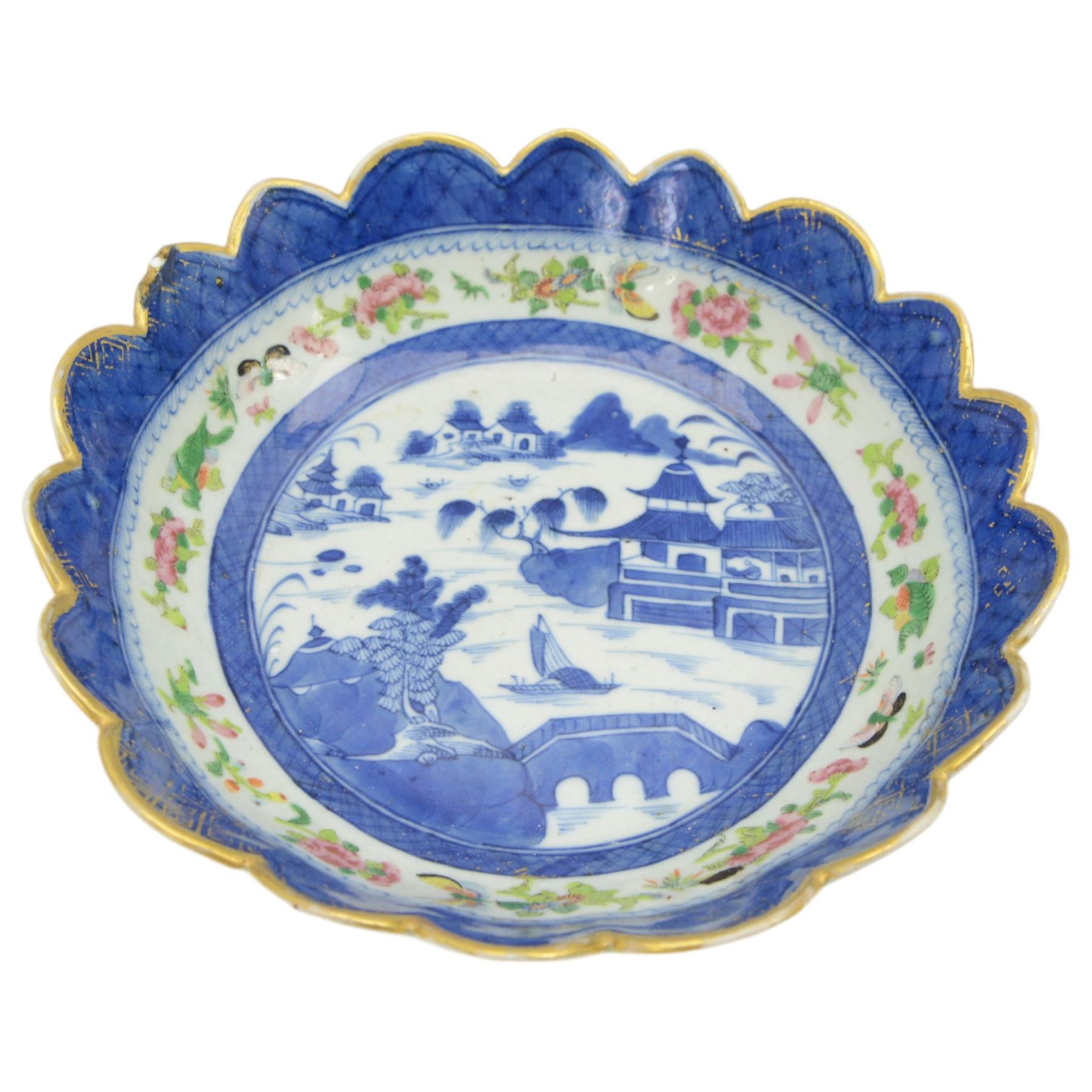 19th century/ early 20th century Chinese Canton blue and white bowl, centrally decorated with a landscape scene, within a famille rose enamelled border and scalloped rim, D26cm together with a Japanese Meiji Imari fluted bowl, decorated cranes, fans and scholar, D24cm (2)