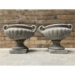 Pair of Victorian design cast stone squat garden urns with handles, pedestal base on square plinth