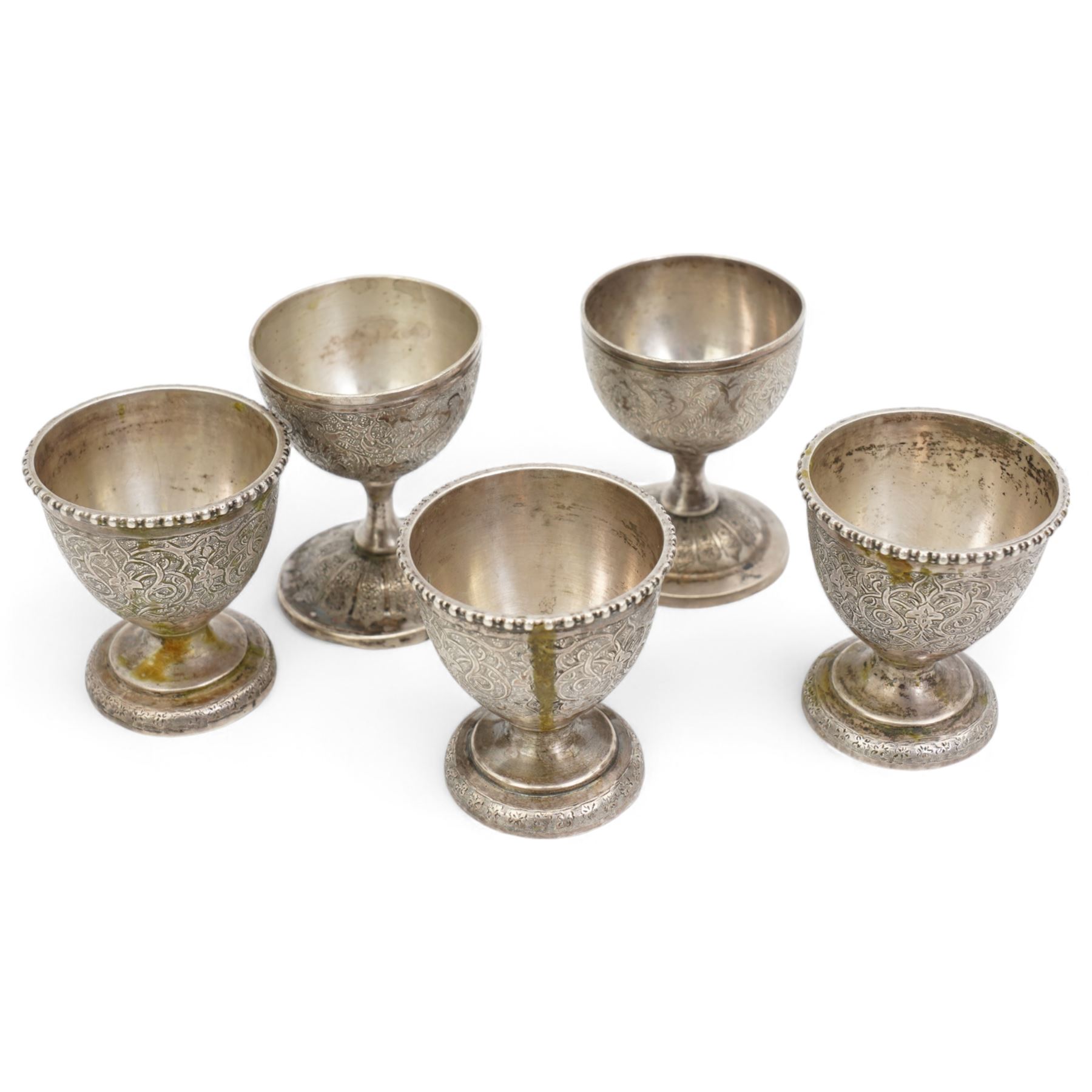 Middle Eastern items comprising five egg cups, pair of pepperettes and four small saucers and a 925 silver pill box